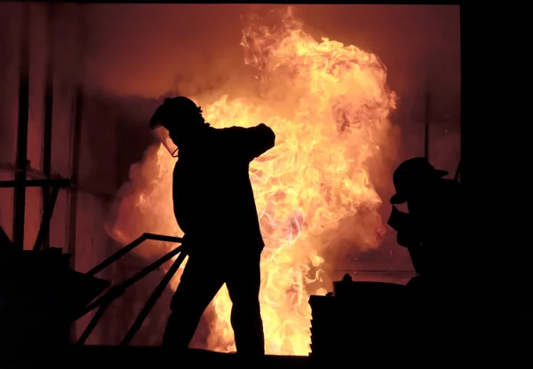 Man is working in the splashing molten iron - Stock Image — Stock Photo, Image