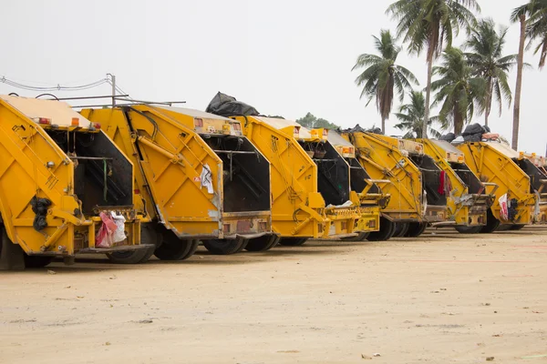 yellow garbage truck