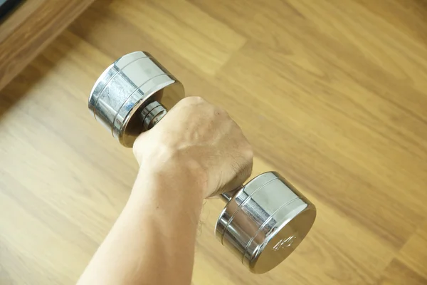 Stock Photo steel dumbell on the wooden floor — Stock Photo, Image