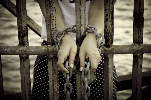 Foto D'archivio Foto D'archivio: Catene arrugginite, catene che legano le mani di una bella giovane donna è legato al ferro e arrestato . Fotografia Stock