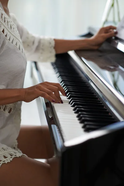 Female hands touching piano keys — Stock Photo, Image