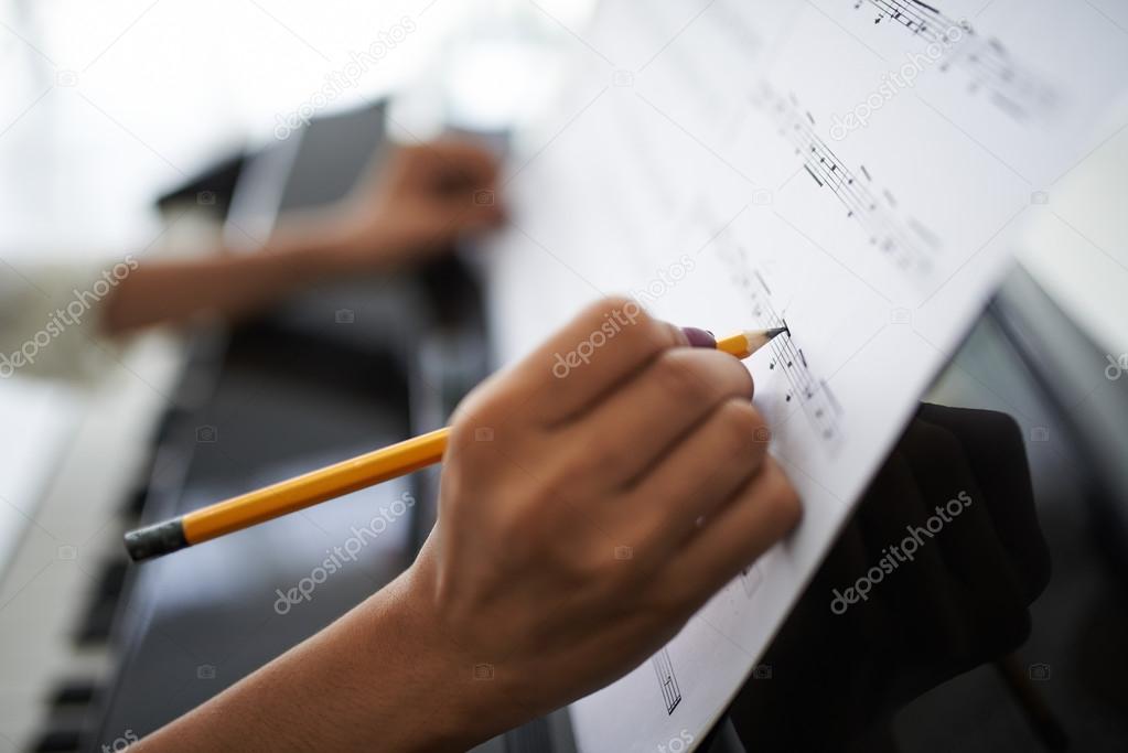 hands correcting music score