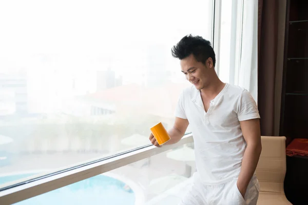 Asian man with a coffee cup — Stock Photo, Image