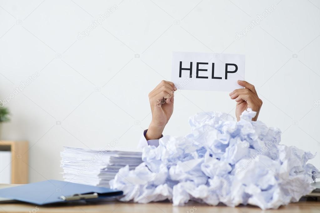 Person under heap of crumpled papers