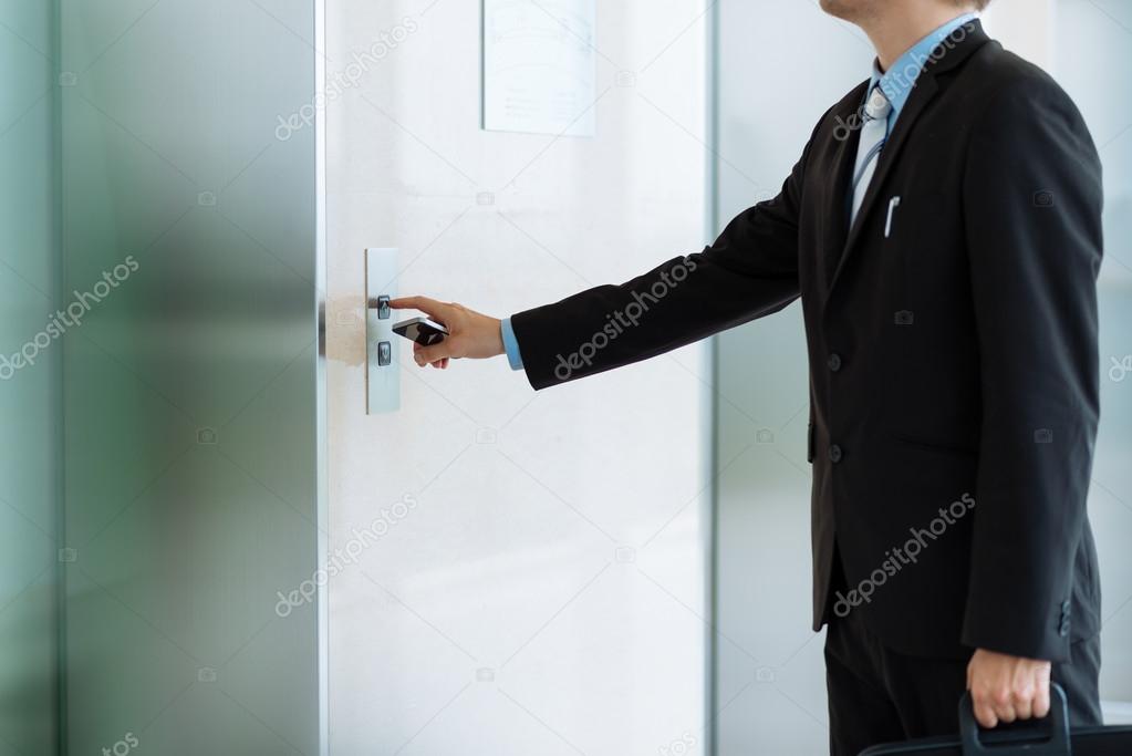 businessman calling elevator