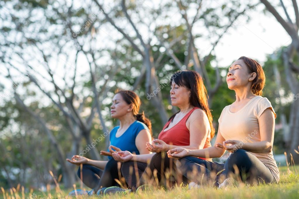 women sitting in lotus position