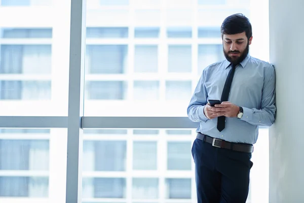 Businessman at big window — Stock Photo, Image