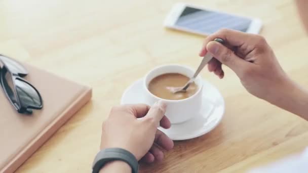 Businessman stirring coffee. — Stock Video