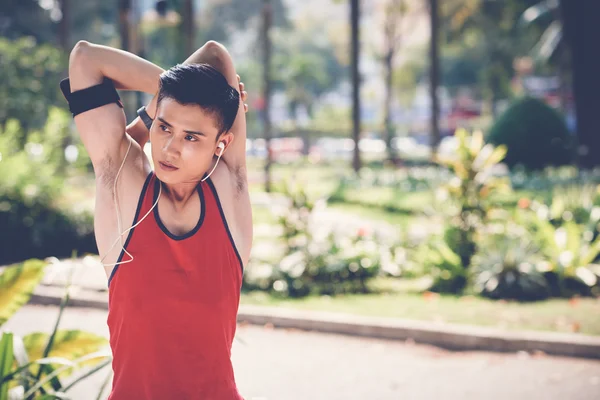 Handsome fit man stretching arms — Stock Photo, Image