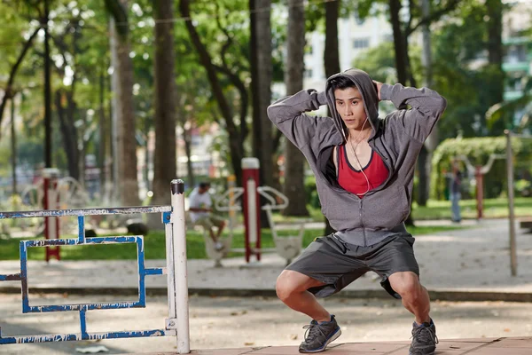 Passen man doen squats — Stockfoto