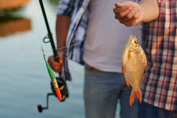 Hand innehav fisk på kroken — Stockfoto