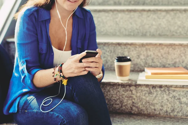 Woman in earphones listening to music — Stock Photo, Image