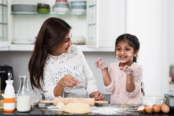 Little girl cooking with her mother — Stock Photo, Image