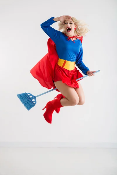 Superwoman flying on broom — Stock Photo, Image