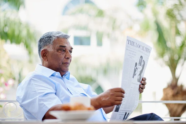 Indian man reading newspaper — Stock Photo, Image