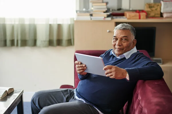 Mature man reading e-book — Stock Photo, Image