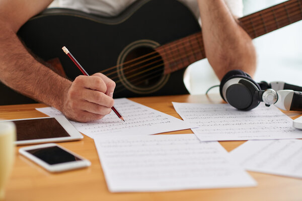 composer examining sheets with notes