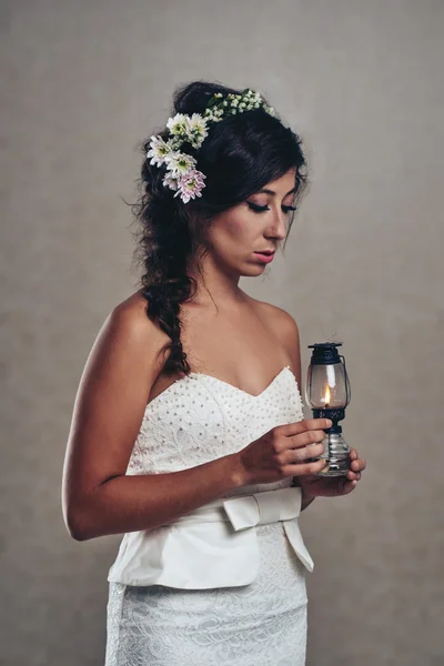 Bride holding oil lamp — Stock Photo, Image