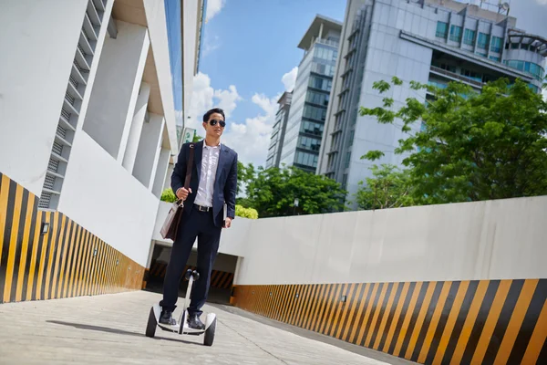 Businesman riding to work on hoverboard — Stock Photo, Image