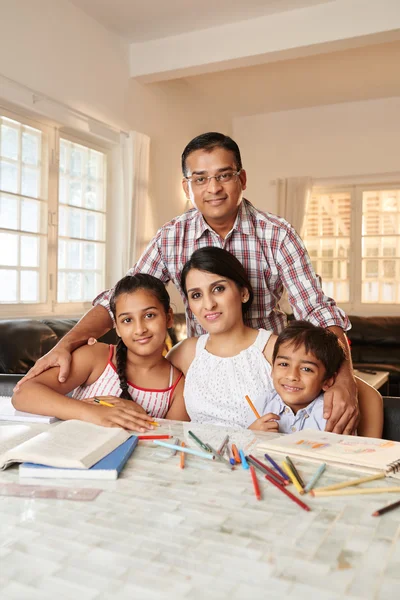 Children doing homework with their parents — Stock Photo, Image