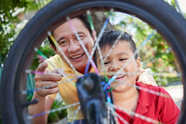 Father and son spinning wheel — Stock Photo, Image
