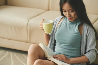 Çay içme ve bir kitap okuma kadın