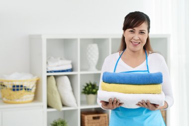 Housewife holding fresh towels