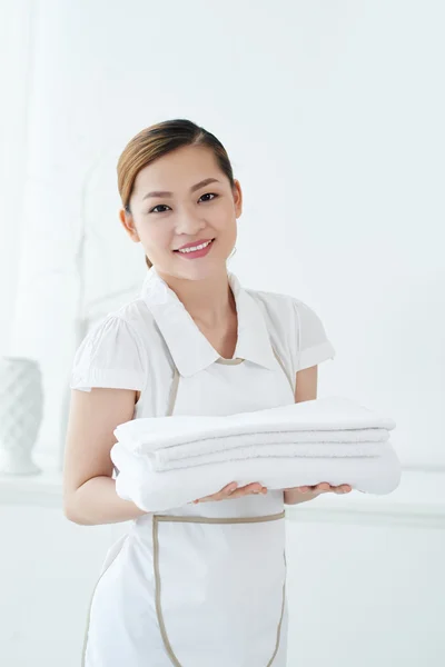 Chambermaid with stack of fresh towels — Stock Photo, Image