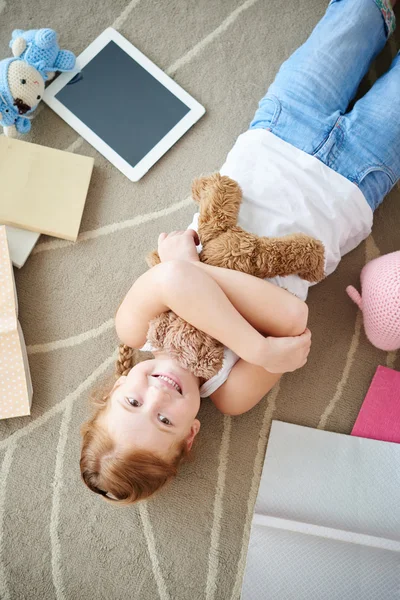 Sonriente chica abrazando su oso — Foto de Stock