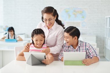 çocuk ve öğretmen tablete app kullanarak