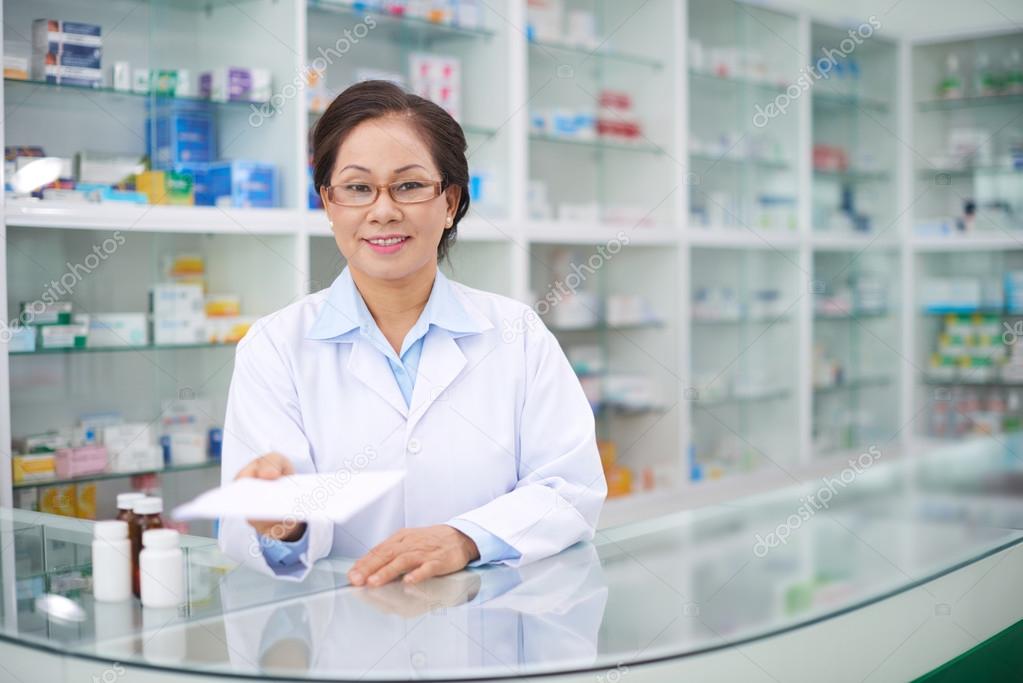 female pharmacist giving prescription