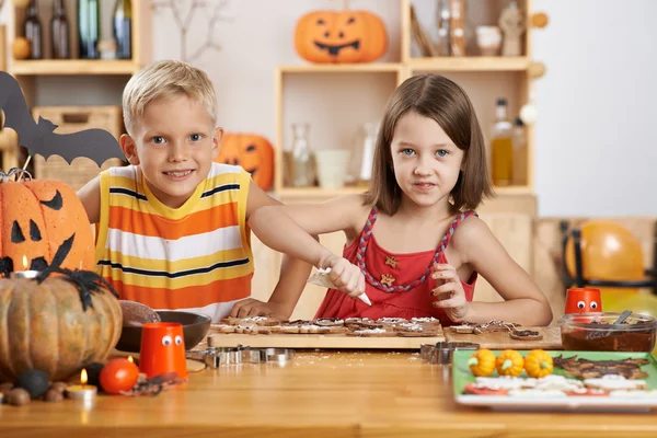 Bror och syster dekorera kakor — Stockfoto