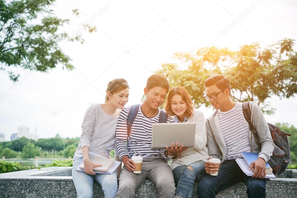 students watching something on laptop