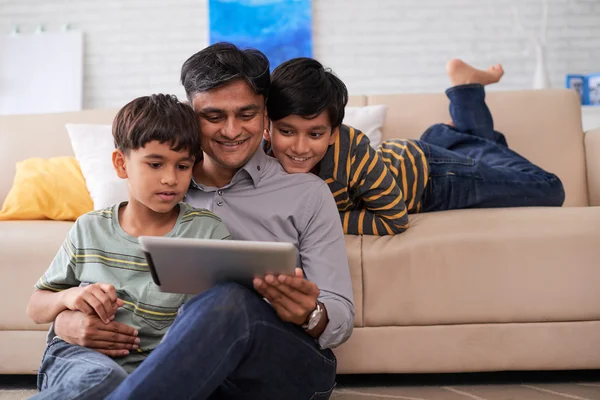 Father and sons enjoying movie — Stock Photo, Image