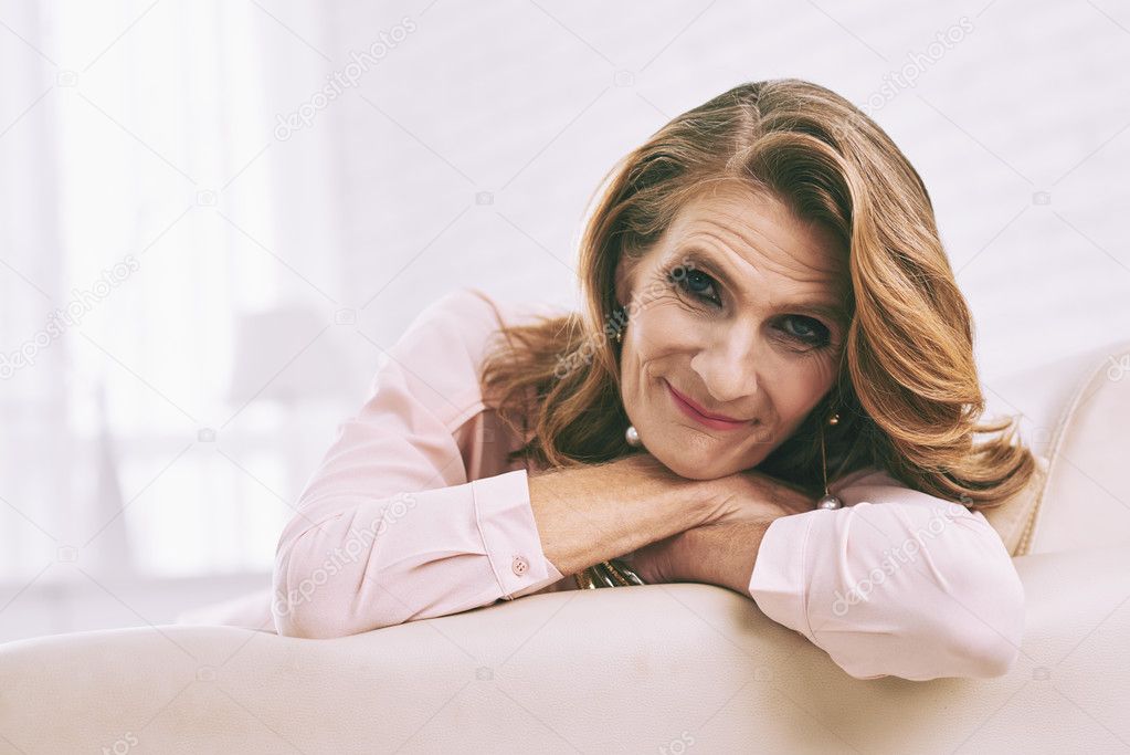woman resting on sofa at home