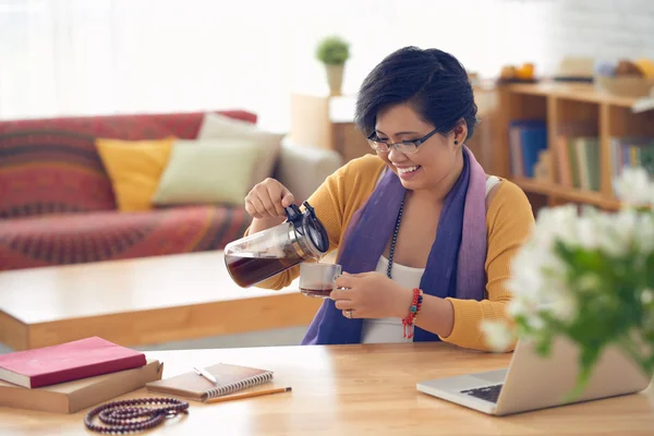 Vrouw gieten koffie in Beker — Stockfoto