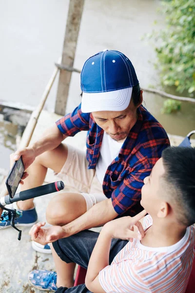 Mature Father His Preteen Son Discussing Hobbies Fishing Together Lake — Stock Photo, Image