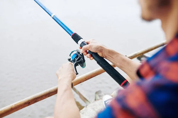 Fisher Plaid Shirt Holding Spinning Rod Twisting Coil — Stock Photo, Image