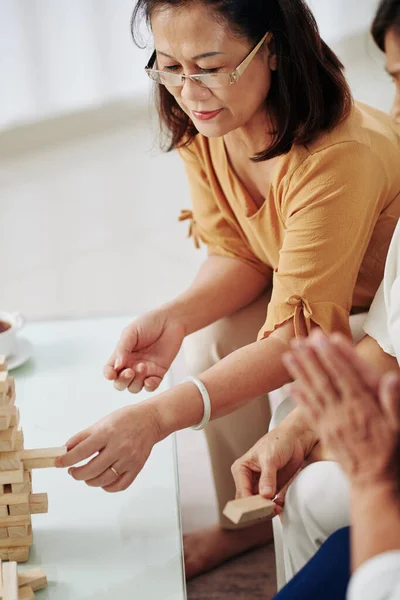 Senior Woman Glasses Removing One Wooden Block Constructed Tower — Stock Photo, Image