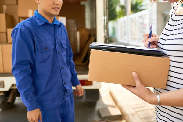 Moving House Company Courier Blue Uniform Looking Woman Signing Delivery — Stock Photo, Image