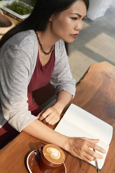 Pensive Frowning Young Asian Woman Drinking Coffee Filling Planner Plans — Stock Photo, Image