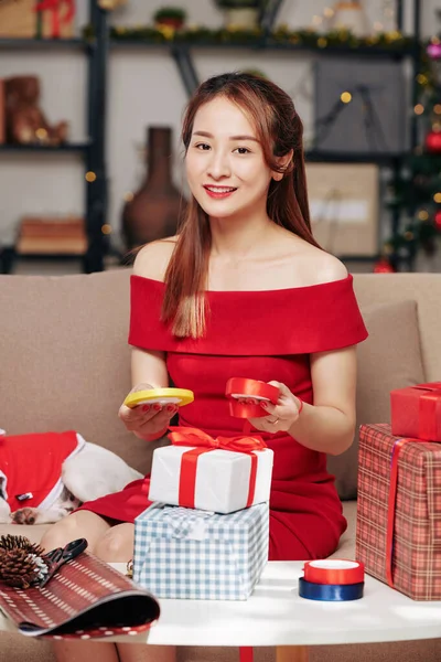 Beautiful Young Asian Woman Red Dress Choosing Ribbon Color Wrapping — ストック写真