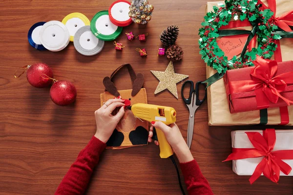 Hands Person Gluing Red Nose Deer Gift Package Table Presents — ストック写真