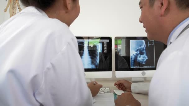 Back View Male Female Asian Doctors Sitting Together Desktop Looking — Stock Video