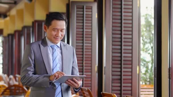 Medium Shot Middle Aged Asian Businessman Standing Restaurant Tablet His — Stock Video