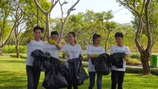 Panorama Jóvenes Voluntarios Asiáticos Que Van Juntos Con Bolsas Basura — Vídeo de stock