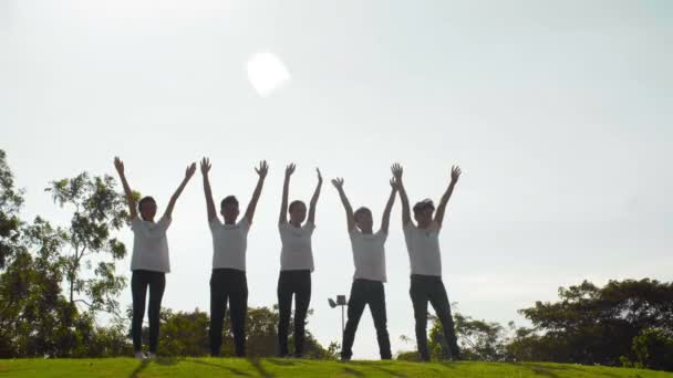 Wide Shot Several Asian Teenagers Volunteer Uniform Standing Lawn Raised — Stock Video