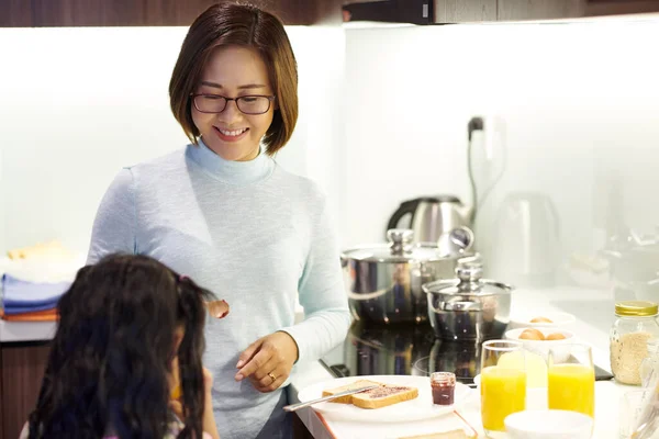 Smiling Mother Giving Little Daughter Spoon Jam Making Her Sandwich — Stock Photo, Image
