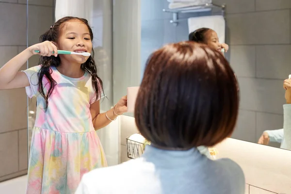 Happy Little Asian Girl Brushing Teeth Bathroom Looking Mother — Stock Photo, Image