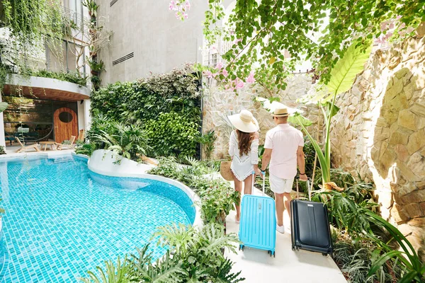 Young Couple Suitcases Walking Room Luxurious Spa Resort View Back — 스톡 사진